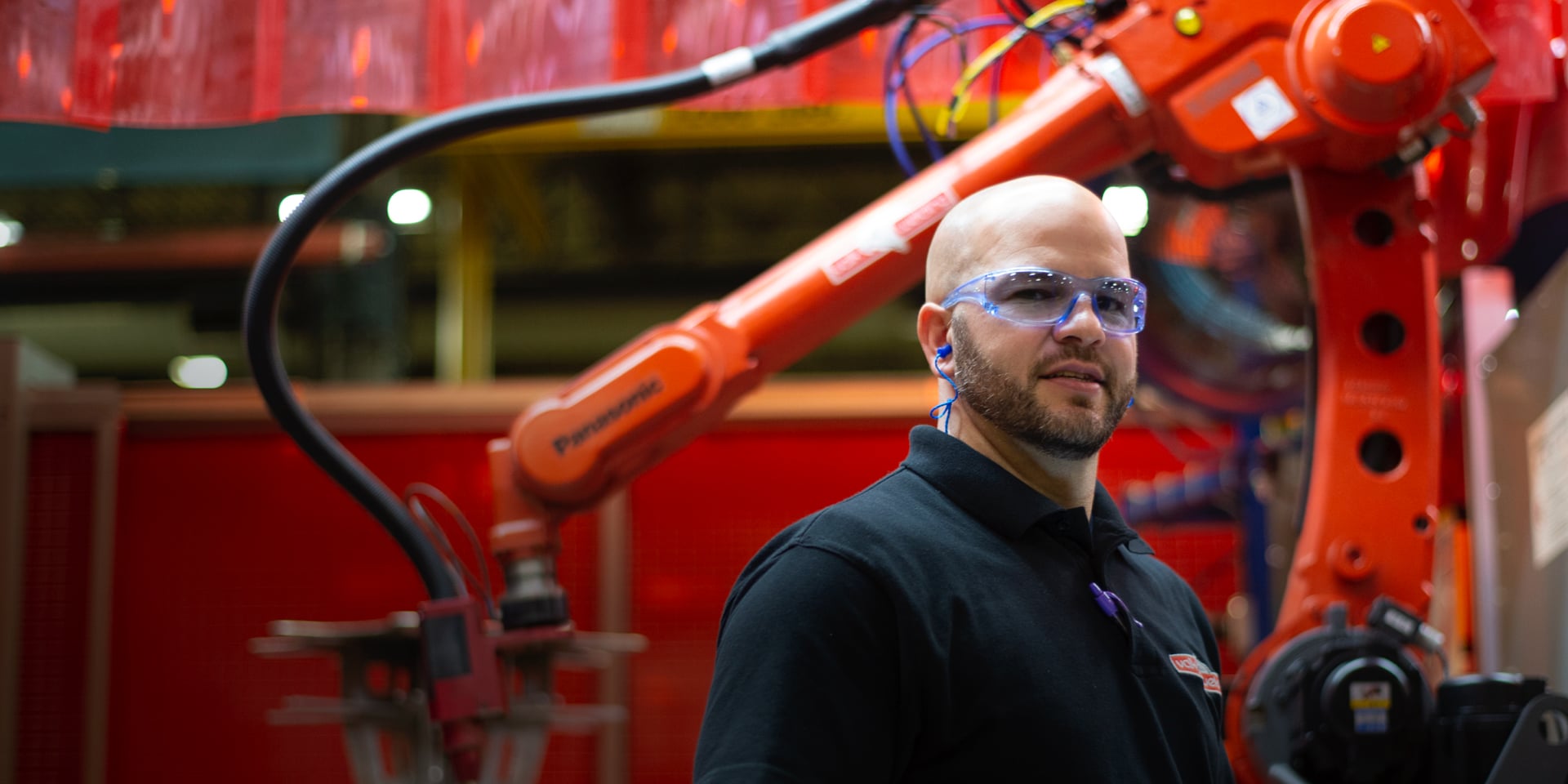Koch Industries employee and a welding robot